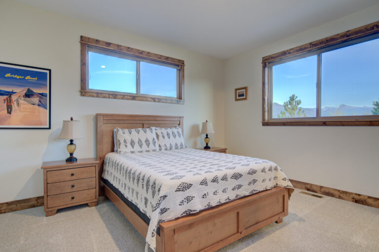 Bedroom with mountain-view windows at Montana Skies vacation rental in Livingston