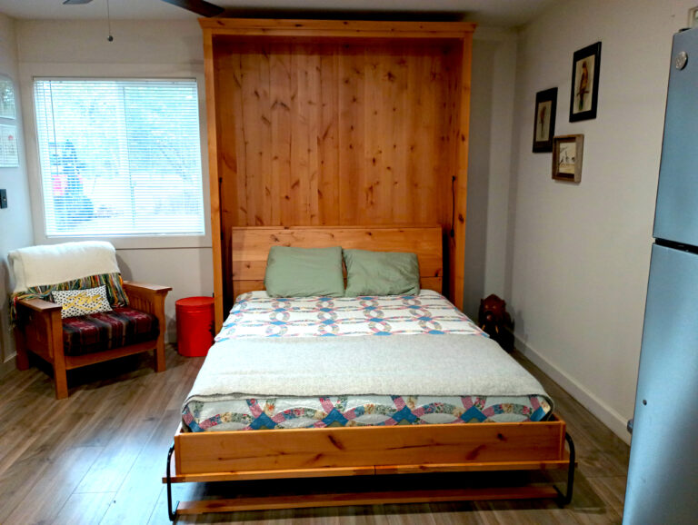Bedroom with wood headboard wall at Almosta Ranch vacation rental near Bozeman