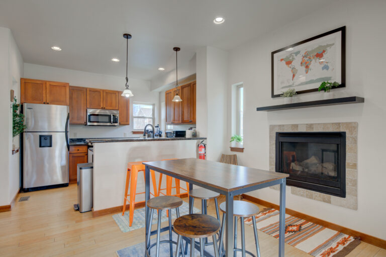 Open kitchen and dining area with fireplace at the Northside Condo in Bozeman
