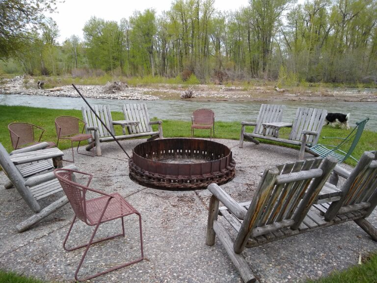 Riverside fire pit with Adirondack chairs on the Gallatin River at the Gallatin River Cabin