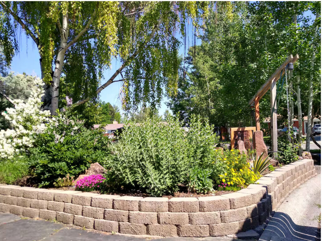 Front garden with stone retaining wall at the Madison Guest House in Bozeman, MT