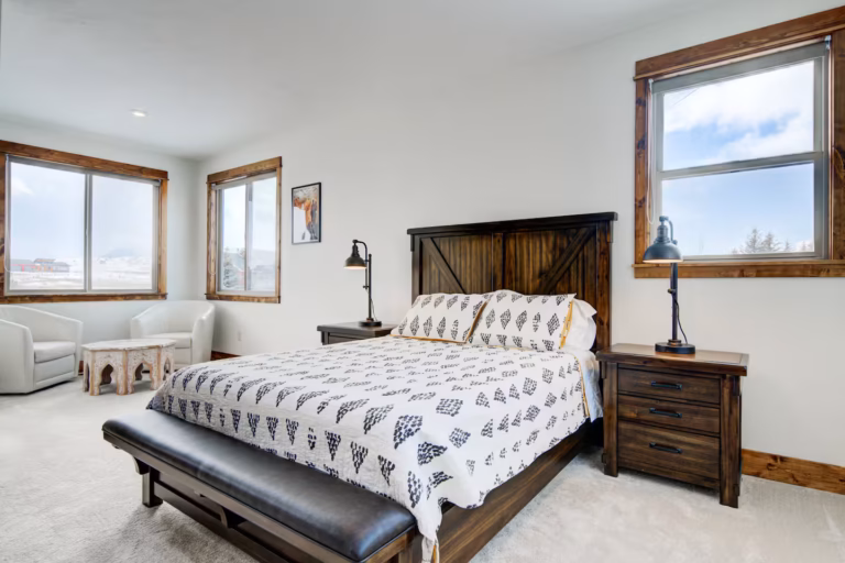 Bedroom with western bedding and bench at Montana Skies in Livingston, MT
