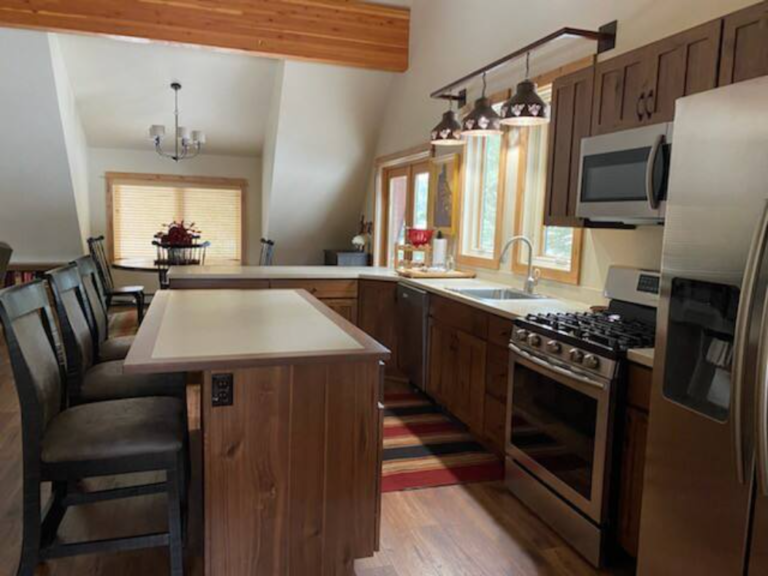 Kitchen with island seating and stainless appliances at the Flying J Bunkhouse, Montana