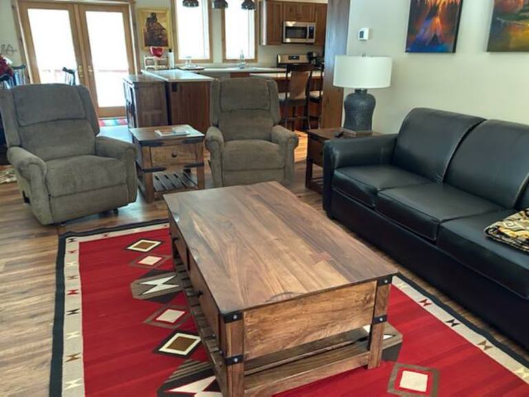 Living room with rustic coffee table and sofa at the Flying J Bunkhouse, Montana