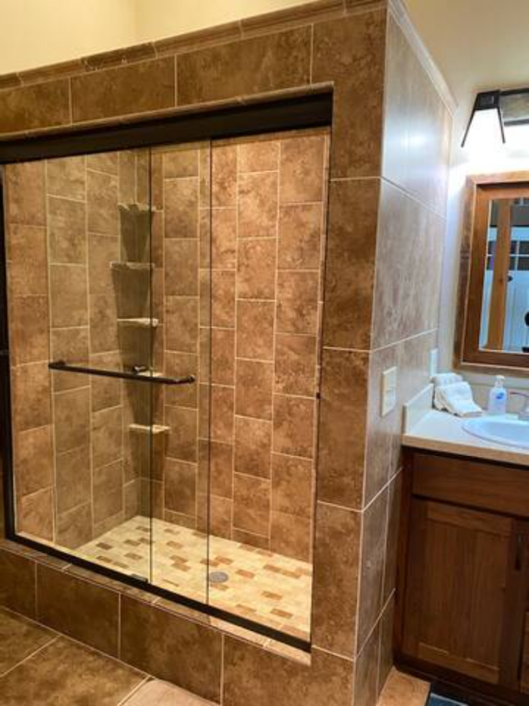 Tiled walk-in shower in the bathroom at the Flying J Bunkhouse vacation rental